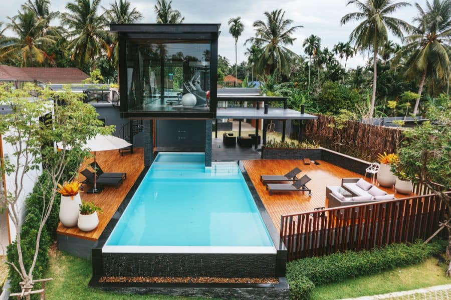 composite-material-pool-deck-ideas-15 luxury home with wood deck and infinity pool
