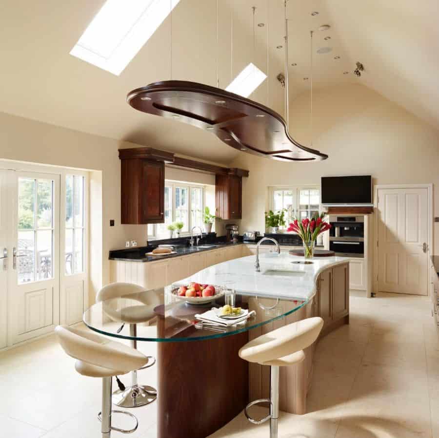 curved island in rustic kitchen with glass extension