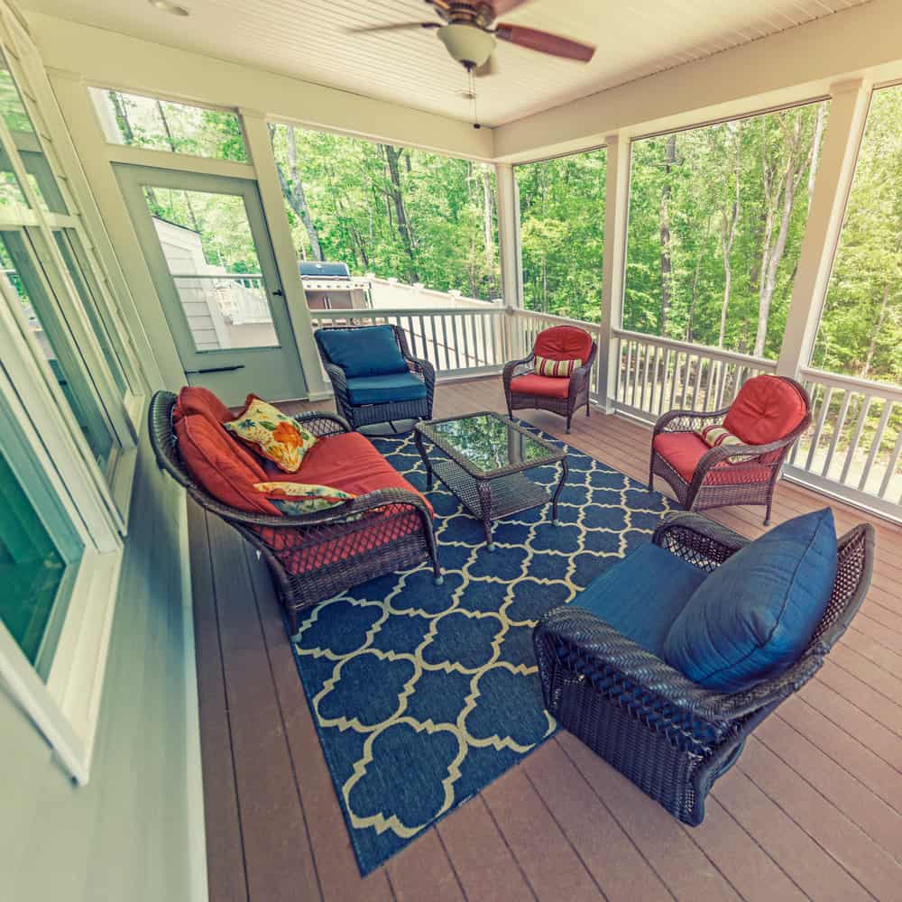 deck-enclosed-patio-ideas-2 enclosed outdoor deck blue pattern carpet wicker furniture ceiling fan