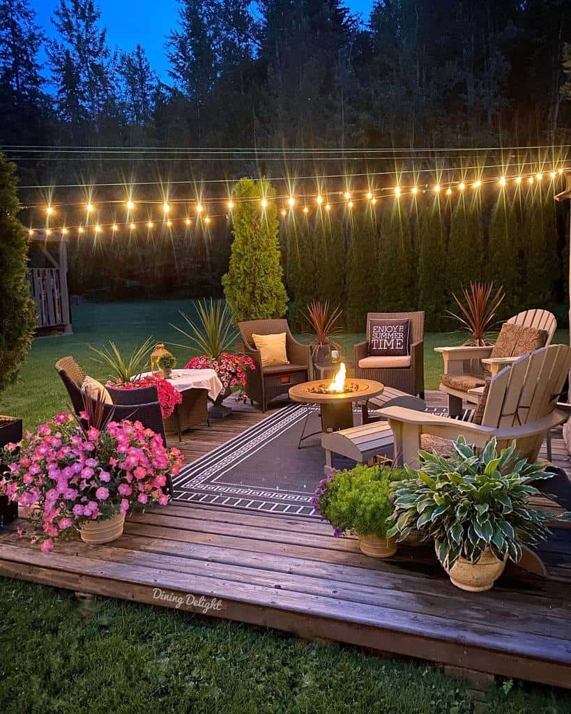 deck-patio-lighting-ideas-dining_delight string lights over backyard deck patio with fire pit