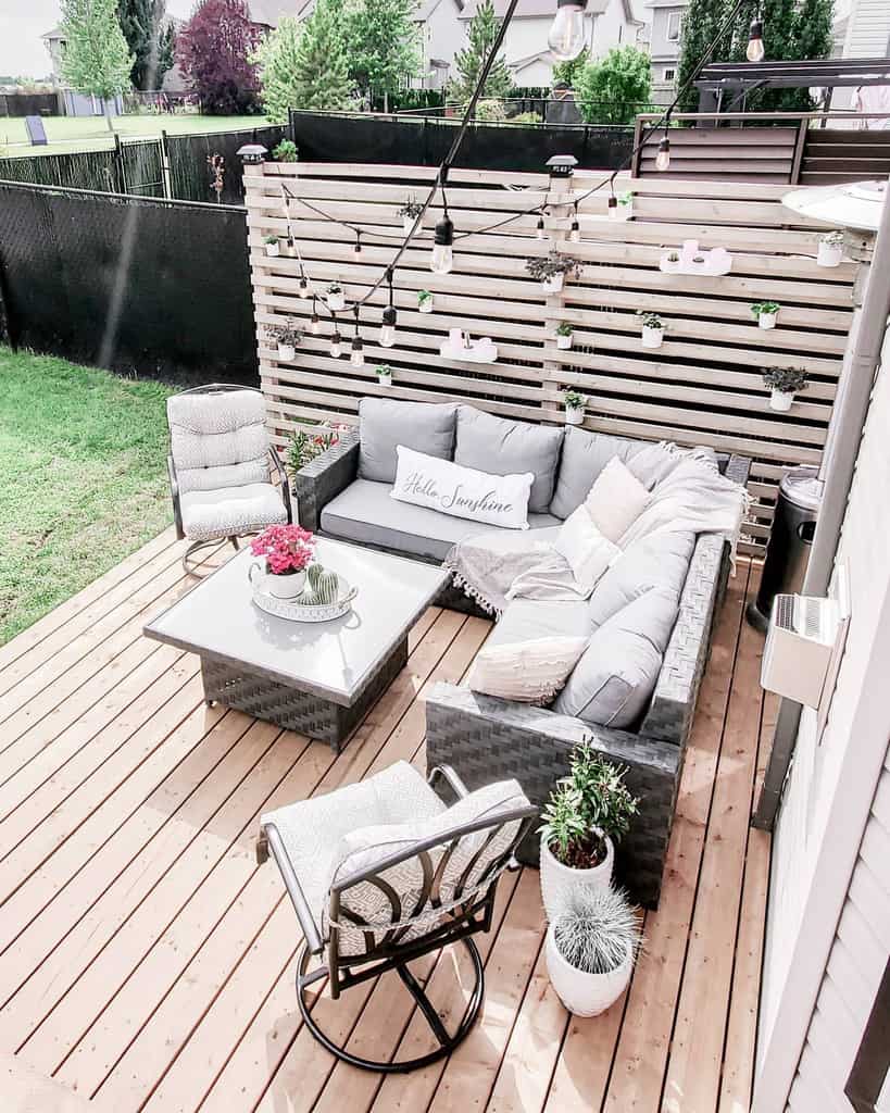 deck-patio-lighting-ideas-illustrious_interiors farmhouse deck patio with l-shape couch and wood slat privacy wall