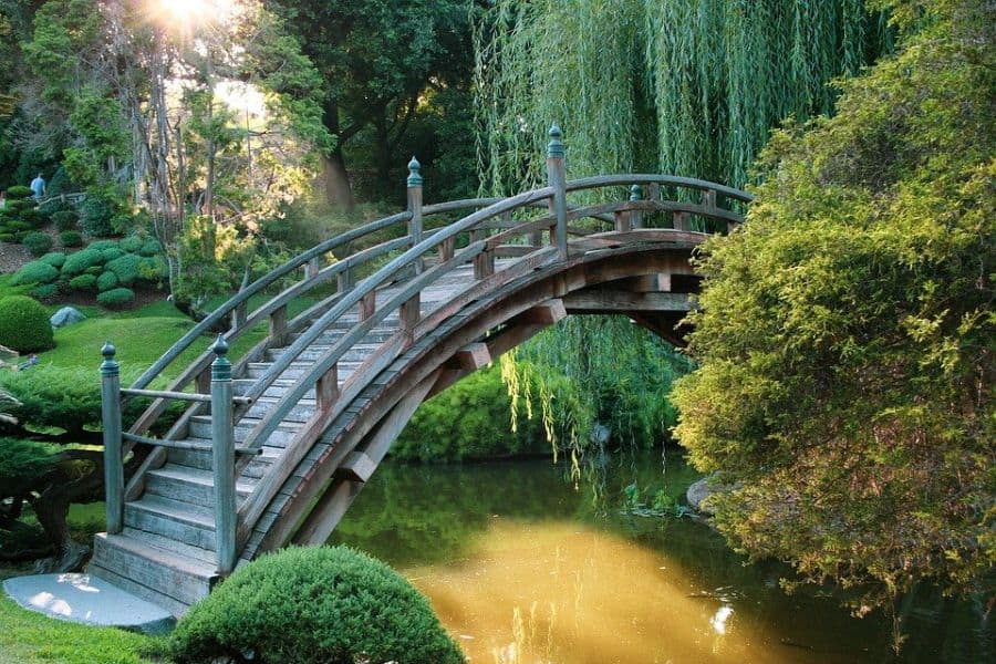 decor-and-religious-sculpture-zen-garden-ideas-1 curved shaped wood bridge garden