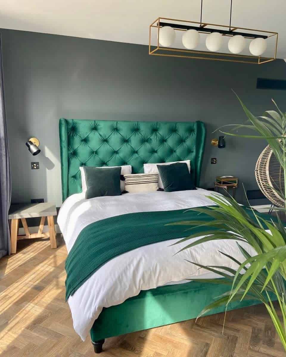 elegant-green-bedroom-ideas-that_overton_house Modern bedroom with emerald green bed, white and green bedding, and a hanging chair