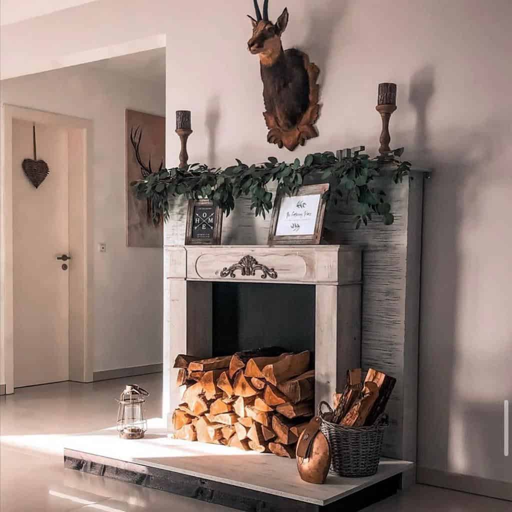 faux-fireplace-wall-ideas-landhaus-no_-6 pink living room faux fireplace framed artwork candlesticks wall mounted deer head