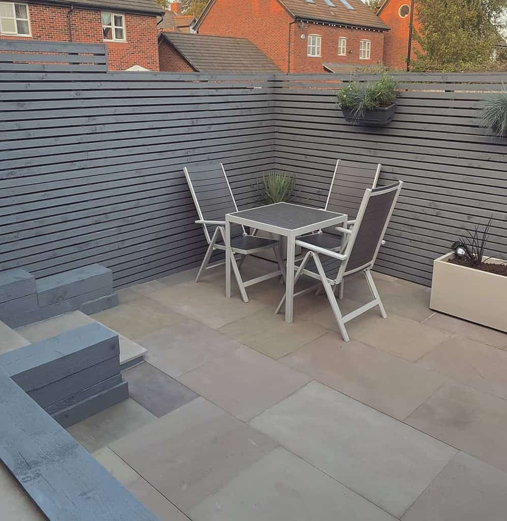 fence-patio-privacy-ideas-love-2be-at_-home_ small concrete paver patio with table and chairs