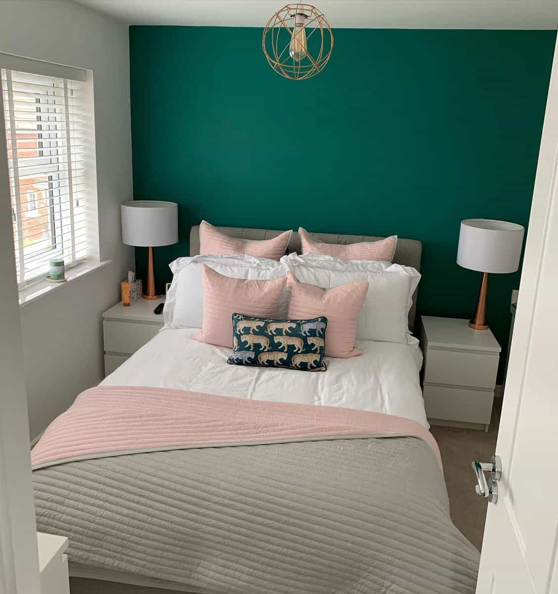 girl-green-bedroom-ideas-archfordhome_dwh Cozy bedroom with teal accent wall, pink pillows and throw, and two bedside lamps on white nightstands