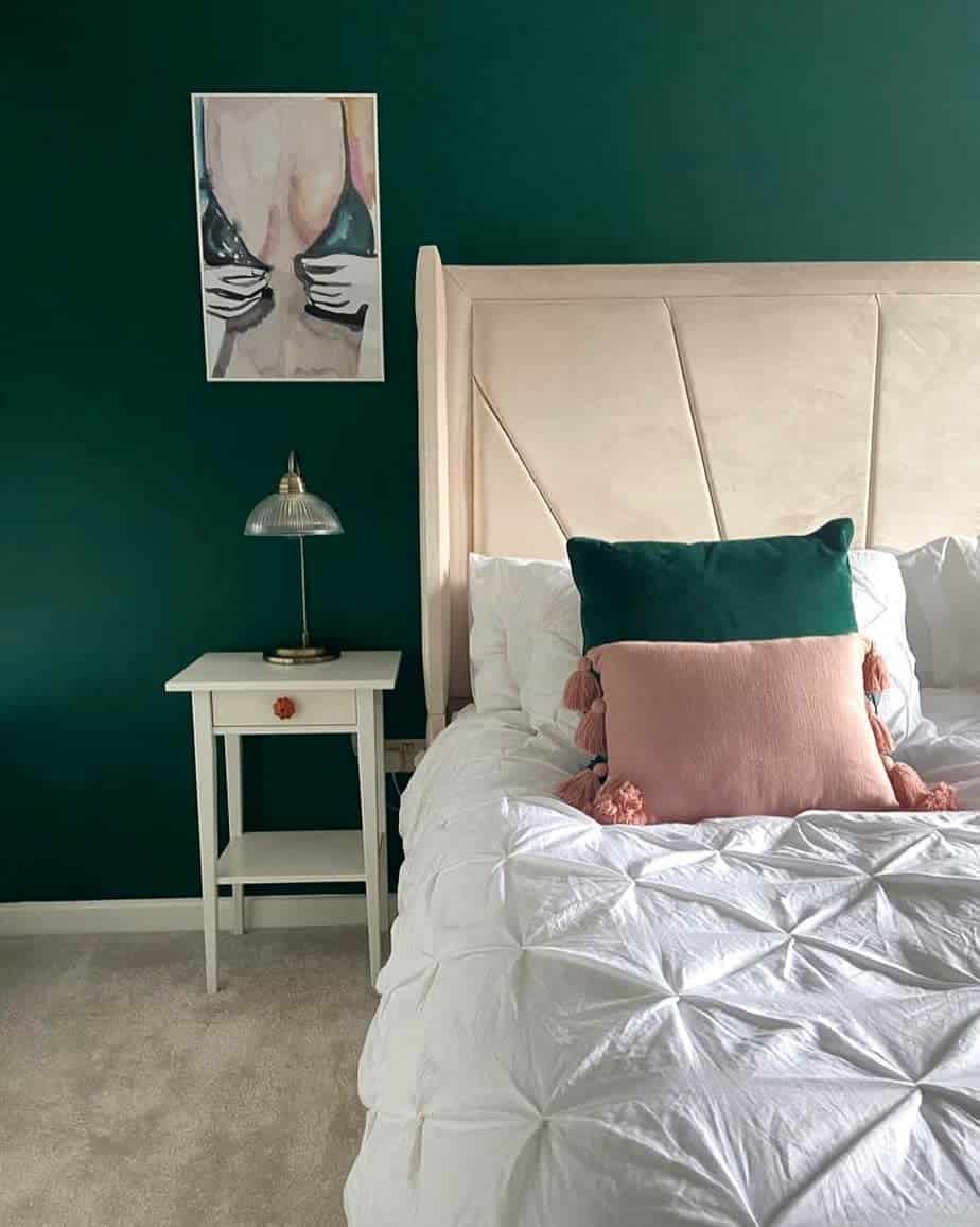 girl-green-bedroom-ideas-pennyfarthinglane Bedroom with green walls, white bed, and nightstand; art of abstract figure with green accents above the lamp