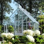 white metal glass greenhouse backyard