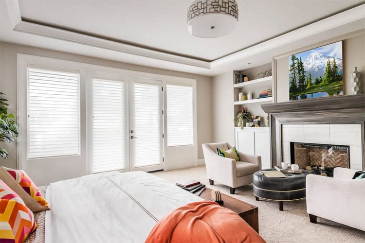 Gorgeous Bedroom with Sitting Area In Front of Fireplace