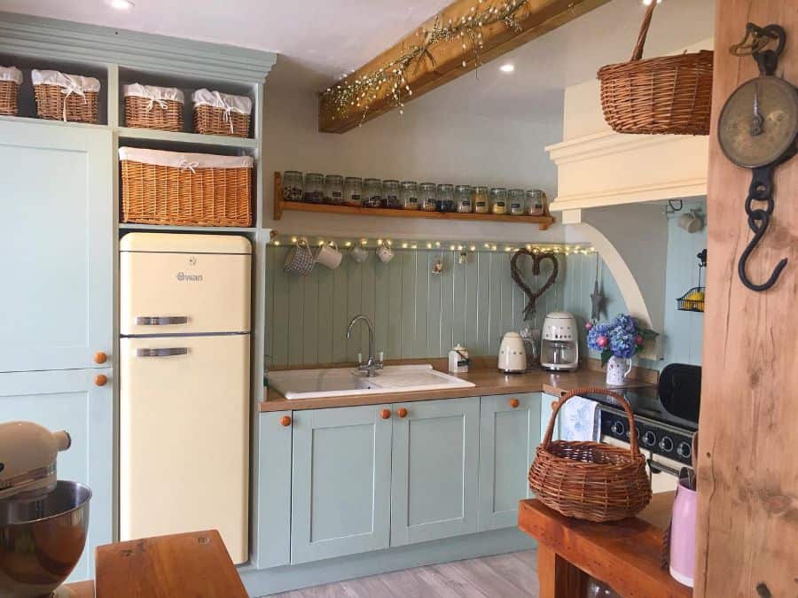 green kitchen cabinets in rustic country kitchen with vintage fridge