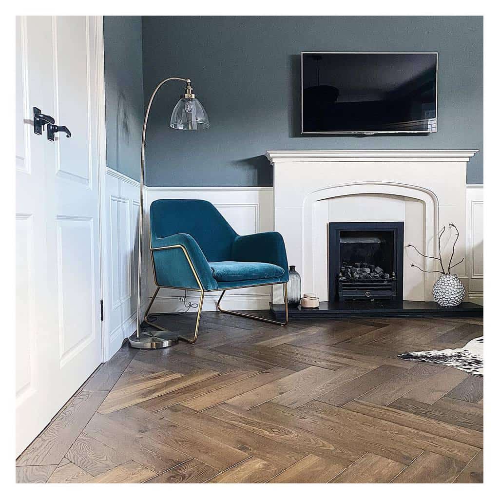 half-wall-paneling-ideas-say_yes_to_the_nest white half wall paneling fireplace wood vinyl floor blue accent chair