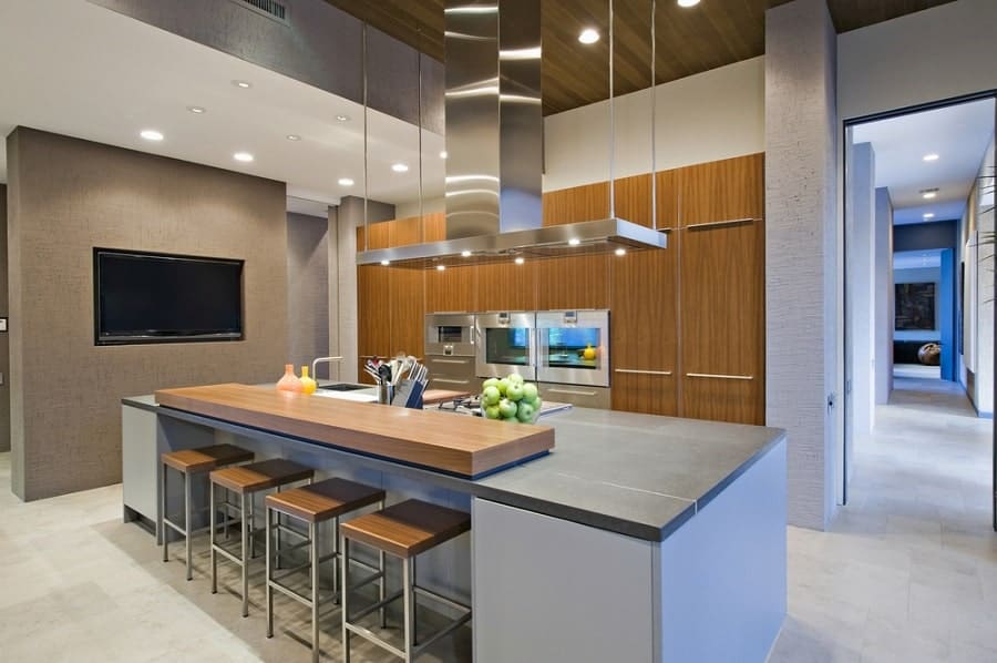 modern kitchen large gray island four stools and brown cabinets