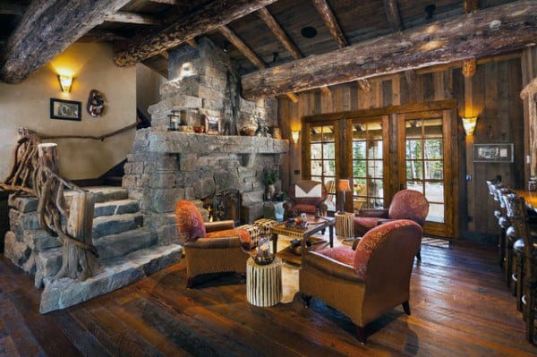 wood cabin living room with stone fireplace and steps