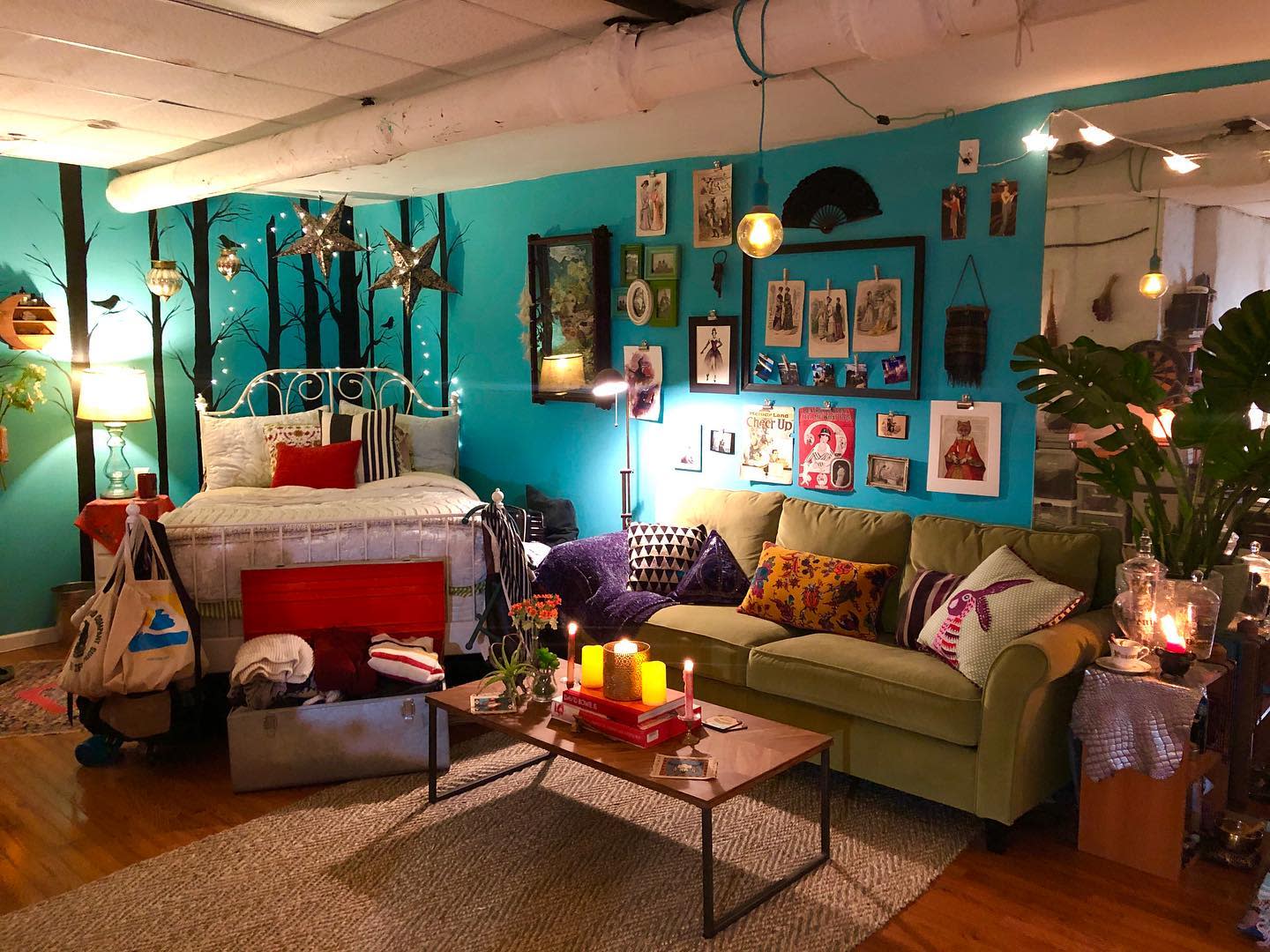 living20room20basement20apartment20ideas20-lindsaymcw Eccentric living room with vibrant decor, teal walls, fairy lights, and eclectic wall art.