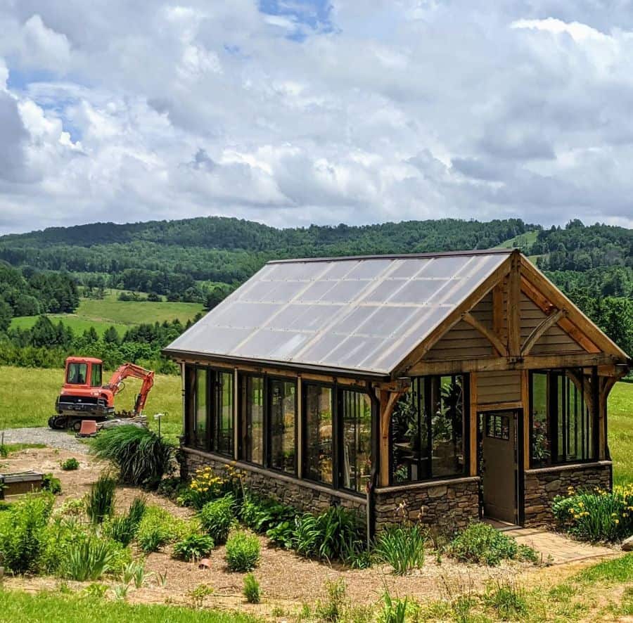 modern-greenhouse-ideas-qberryfarms rustic greenhouse stone base wood and metal frame