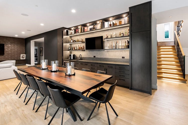 Modern Luxury Basement Bar with Stylish Shelving, Cabinetry and Lighting