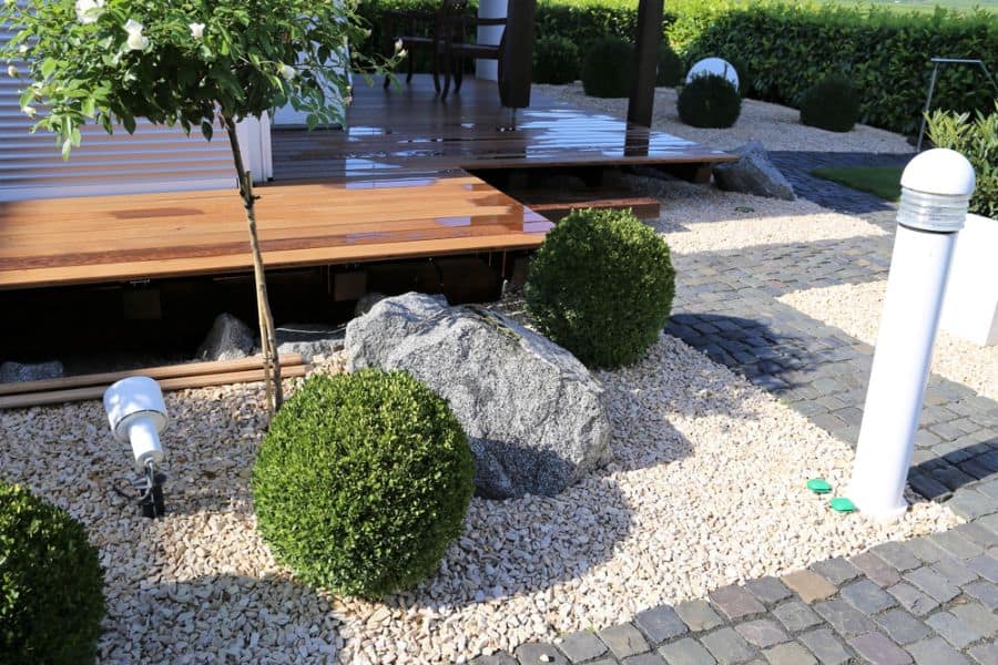 modern-zen-garden-ideas-2 wood deck patio brick paved path stone garden with shrubs