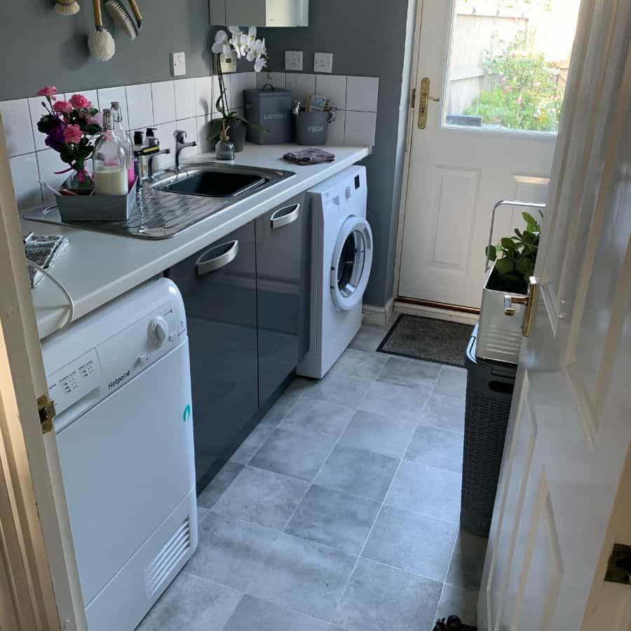small narrow kitchen laundry gray cabinets tile floor