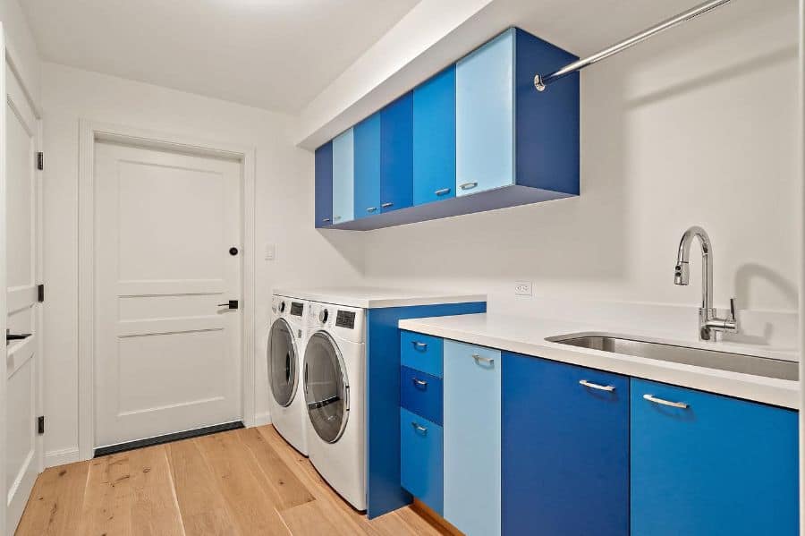 narrow-laundry-room-sink-ideas-sfnorthbayconstruction blue cabinet laundry with large sink washer and dryer