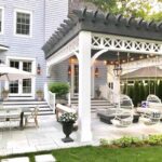 large country style outdoor covered patio hanging egg chairs