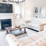 rustic living room white sofas brown wood coffee table black fireplace wall mounted tv