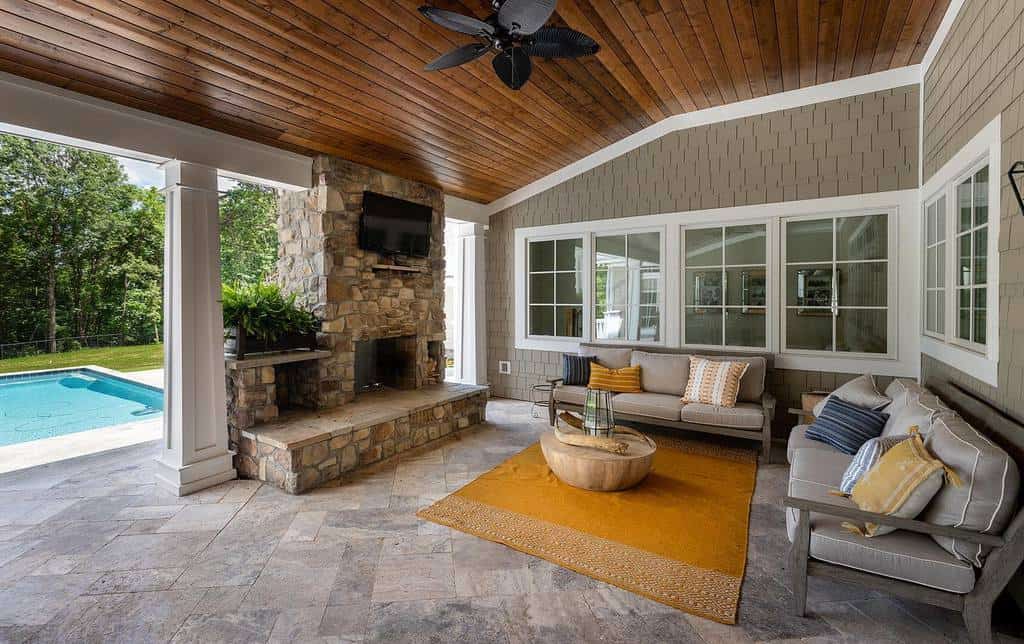 large backyard patio pool stone fireplace
