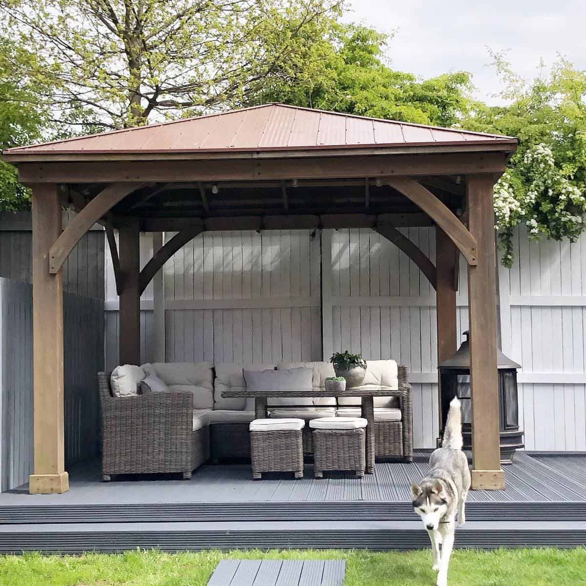 privacy-patio-enclosure-ideas-sammypattersonathome gray deck patio with pergola and wicker furniture
