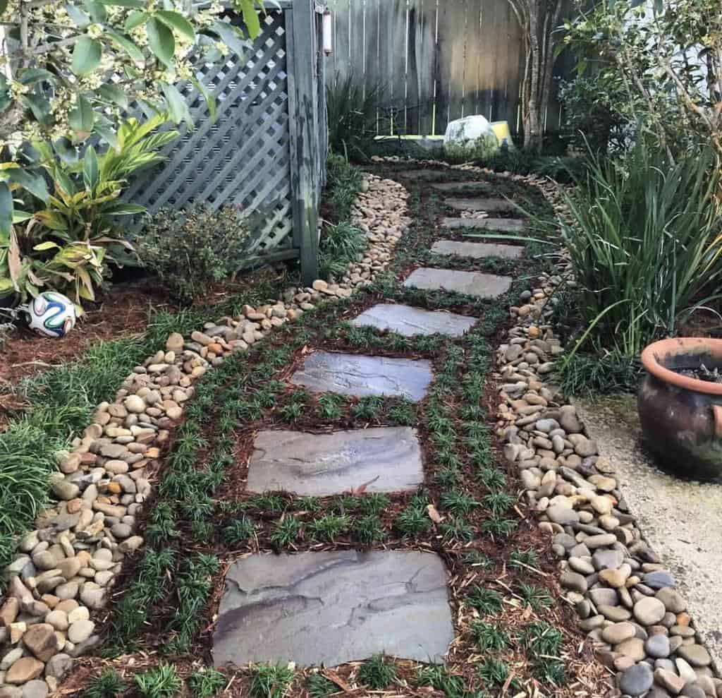 pebbles edging stone pathway backyard