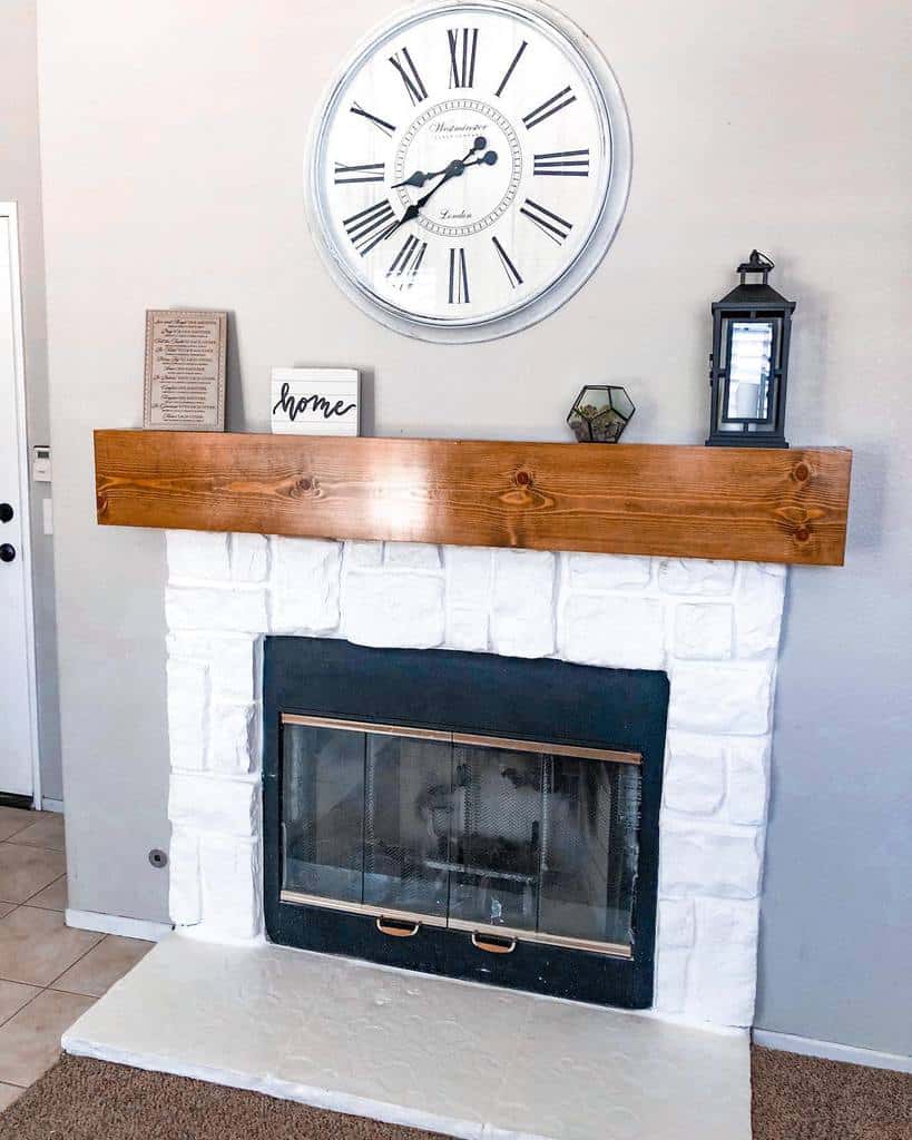 shiplap-fireplace-wall-ideas-lmahandmade white brick fireplace wood plank mantle with lantern wall clock