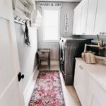 farmhouse laundry with white cabinets gray washer and dryer