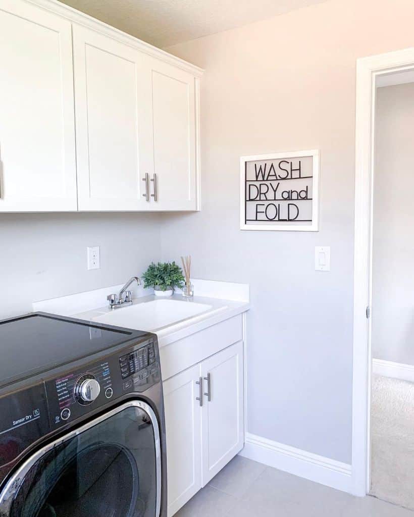 sink-cabinet-laundry-room-sink-ideas-casa_de_columbie simple white laundry with black washer