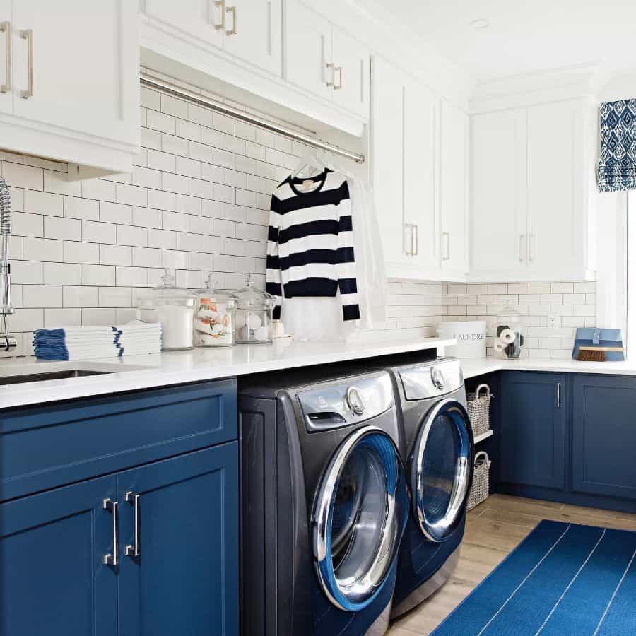 sink-cabinet-laundry-room-sink-ideas-sarahst-amandinteriordesign white and blue cabinet laundry white tile wall