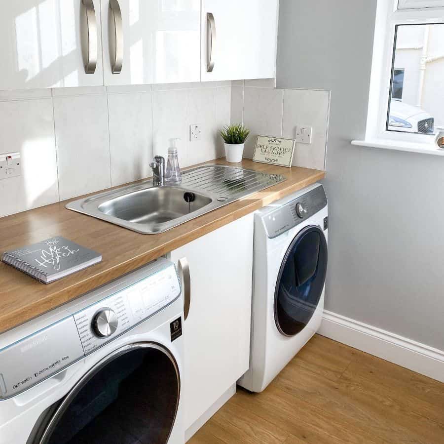 stainless-steel-laundry-room-sink-ideas-standrewscottage washer and dryer in white cabinet laundry