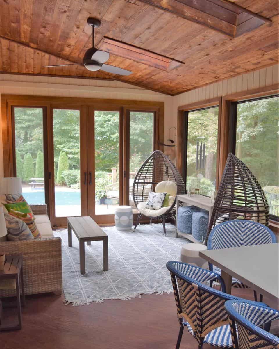 sunroom-patio-enclosure-ideas-redbirdredesign wood sunroom patio enclosure with egg seats