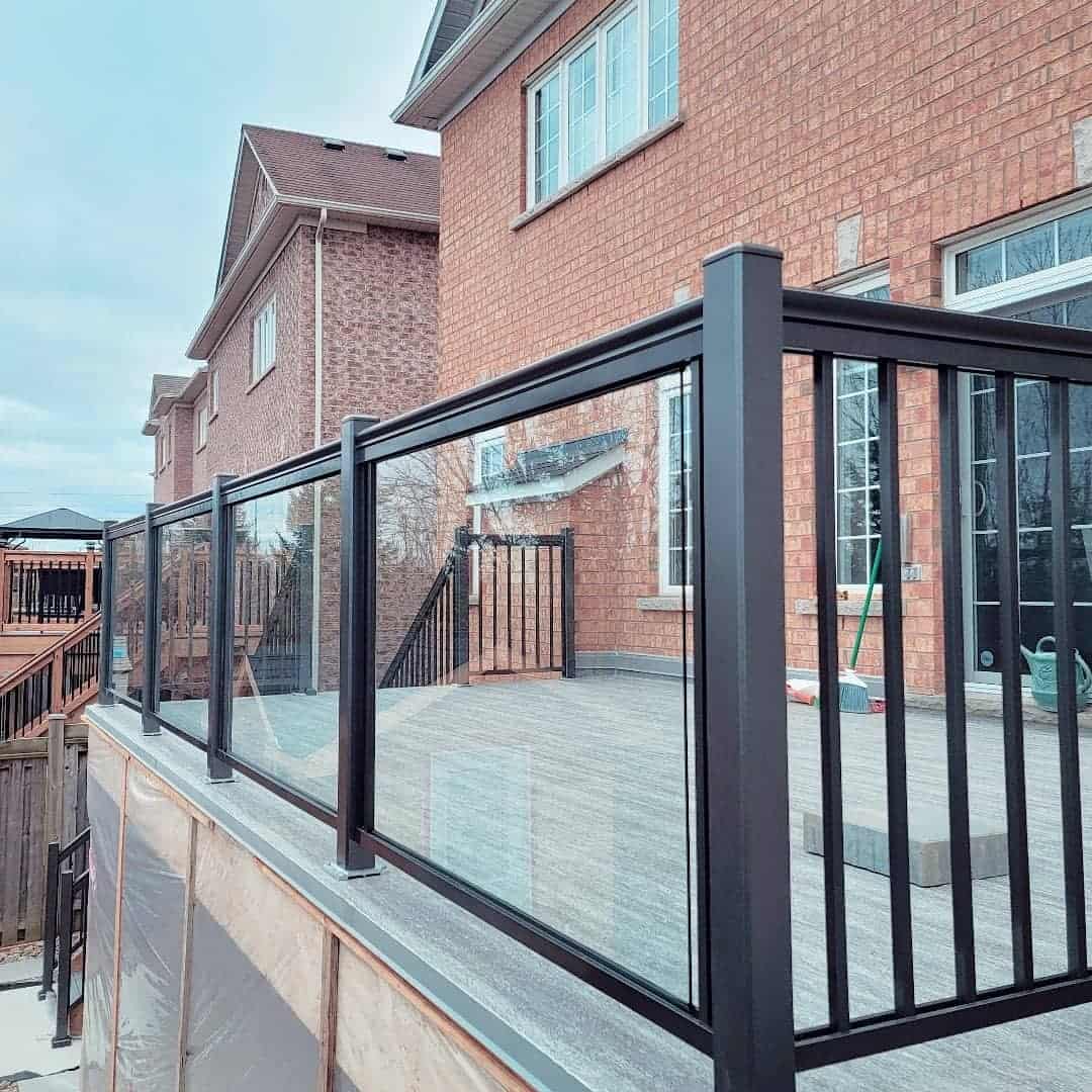 modern two-tone deck gray pavers black glass railing