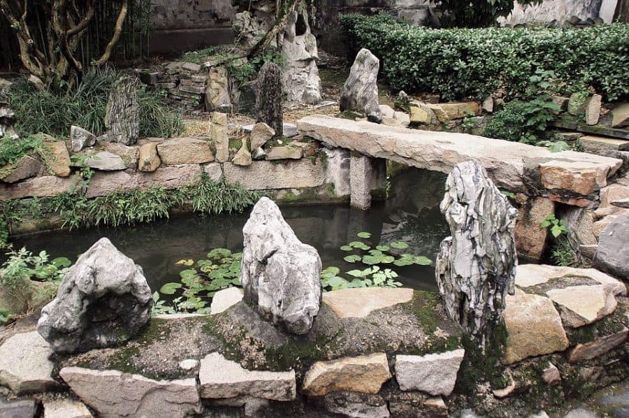 water-feature-zen-garden-ideas-3 small backyard pond with rock bench seat lily pads