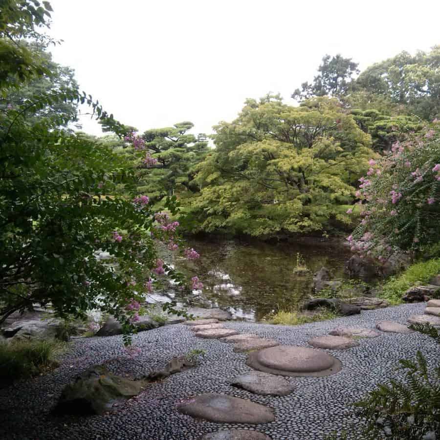 water-feature-zen-garden-ideas-olga-zolo_ large pond in backyard with stone pathway