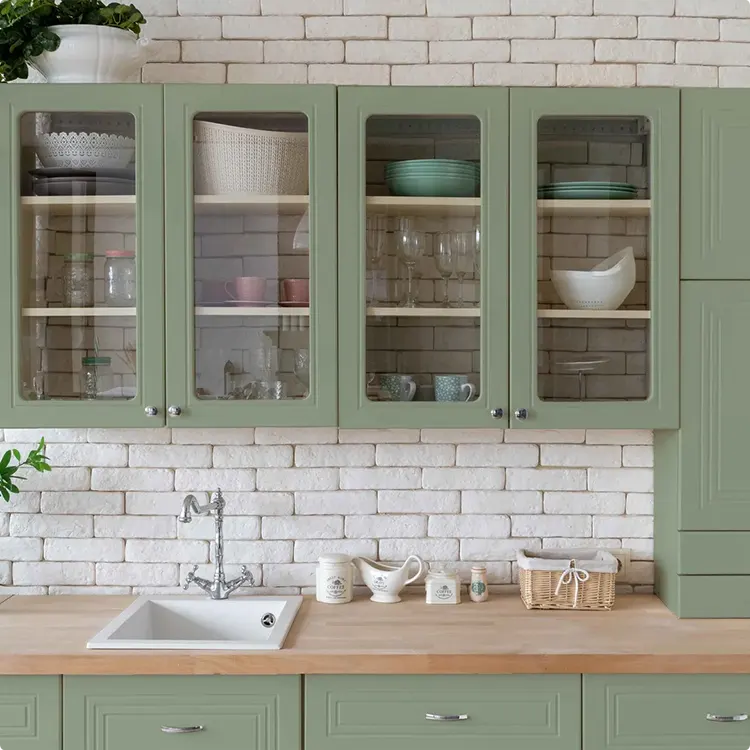 Whitewashed Brick and Soft Green Cabinetry