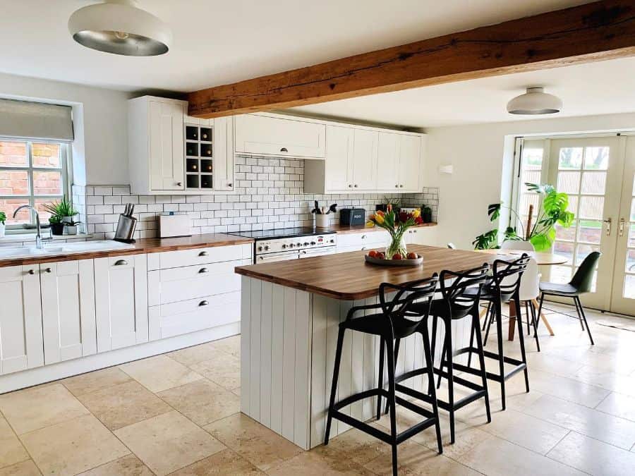 white wood cabinet kitchen with white tile backsplash and island