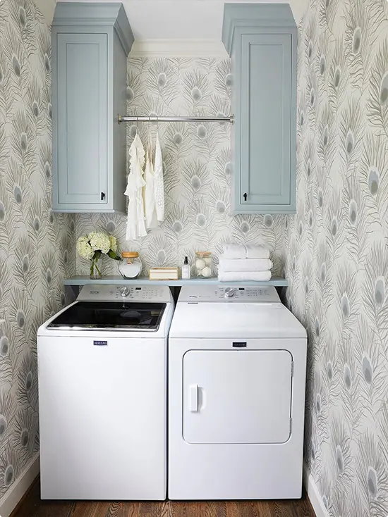 Powder blue upper cabinets with gray feather wallpaper