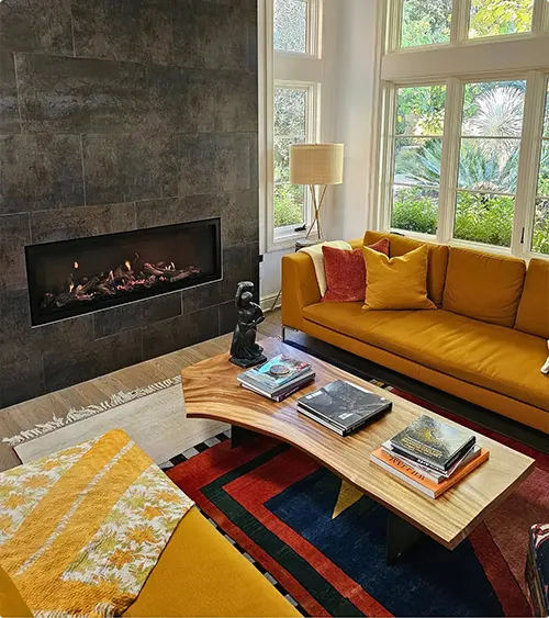Concrete-Look Tile Fireplace with Mustard Yellow Sofa