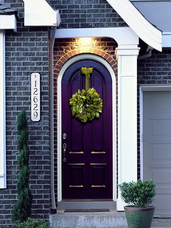 Near-Black Purple Arched Door with Magnolia Wreath