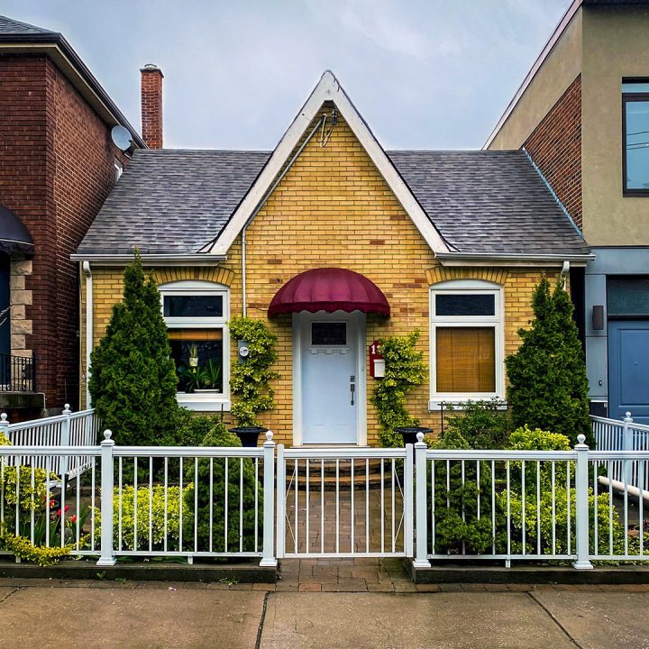 The small cottage and its red door awning