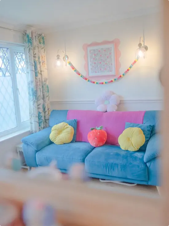 Blue Sofa with Yellow Pillows and Strawberry Cushion