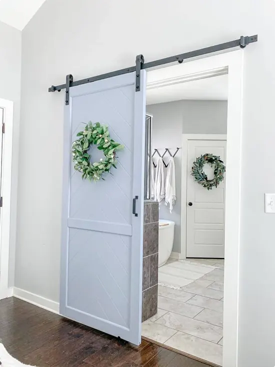 Door with dusty blue color and greenery wreath