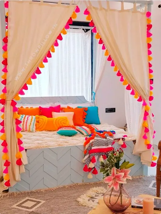 Window Seat with Tassels and Rainbow Pillows