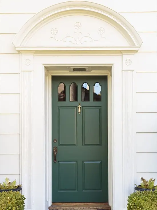 Deep Green Colonial Paneled Door with Floral Pediment and Arched Transom