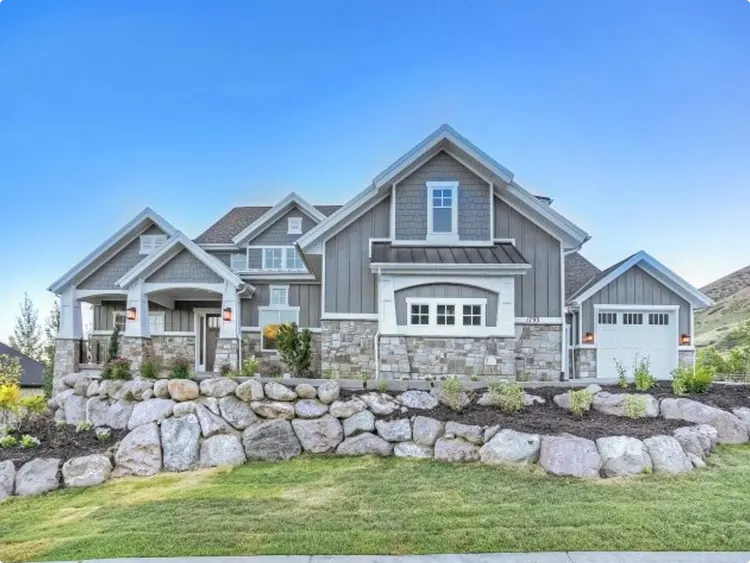 House with a Stone Retaining Wall and Gray Siding