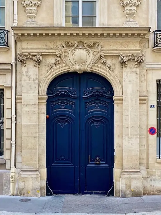 Navy Doors Beneath A Shell Carved Pediment