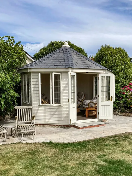 Pale Hexagonal Summer House with Slate Roof and Wicker Seating